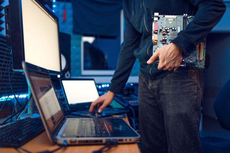 Computer engineer holds PC motherboard Computer engineer holds PC motherboard, network equipment maintenance. IT-manager at his workplace, professional business security